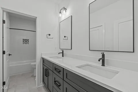 a front view of a house with a yard porch and wooden fence