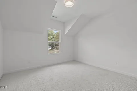 an aerial view of a house with a yard and lake view