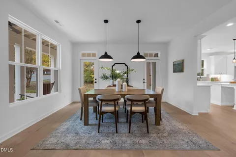 a large kitchen with kitchen island a large counter top space a sink stainless steel appliances and cabinets