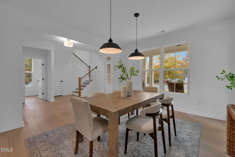 a kitchen with stainless steel appliances granite countertop a stove a sink and white cabinets