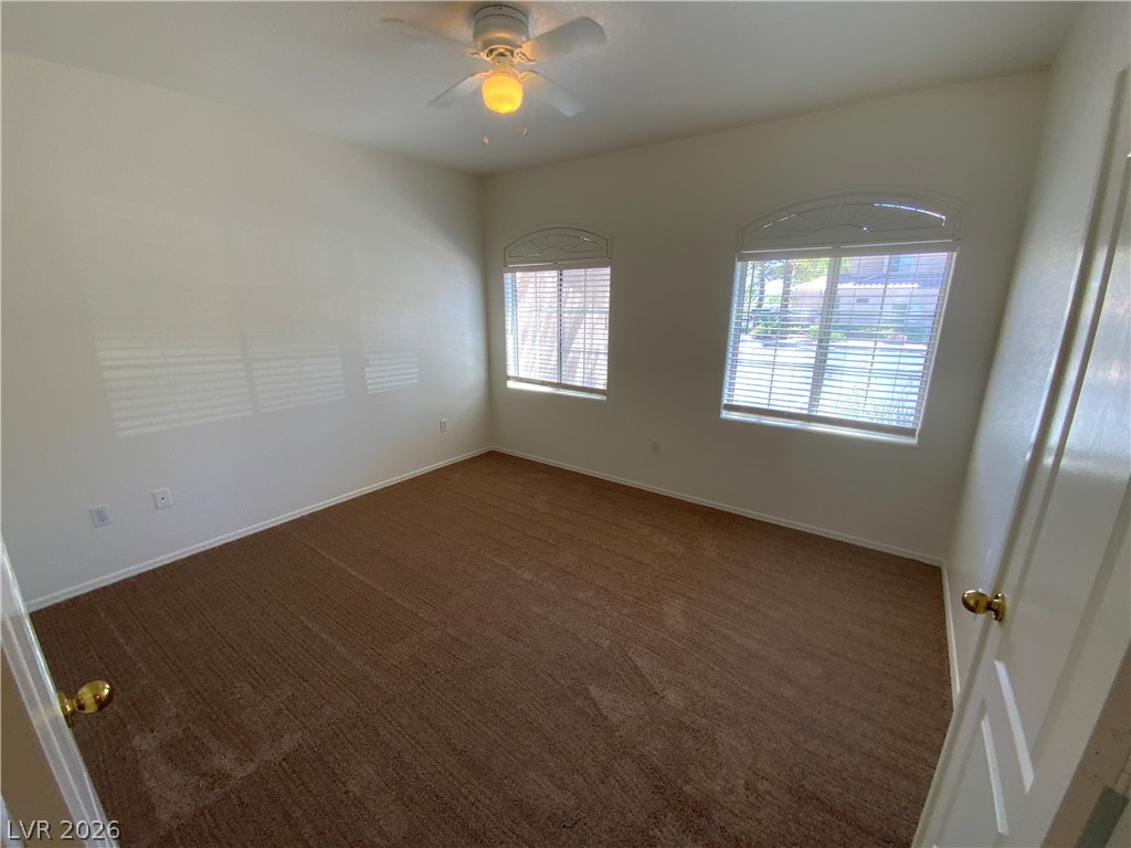 7400 West Flamingo Road, Unit 1039 Las Vegas, NV 89147 - Photo 15 of 40 Well-lit and ready for personalization, this bedroom features soft carpeting and two arched windows.