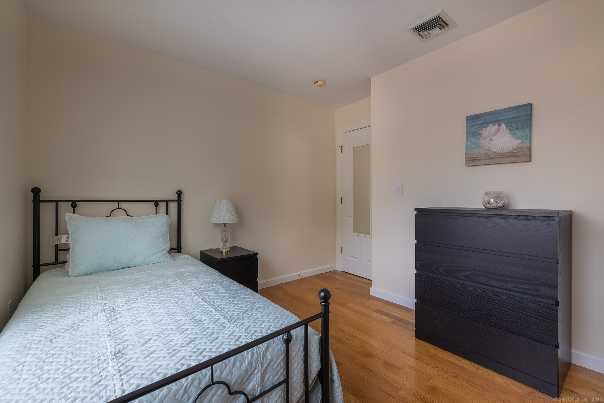 916 Reef Road Fairfield, CT 06824 - Photo 12 of 16 a bedroom with a bed and a dresser
