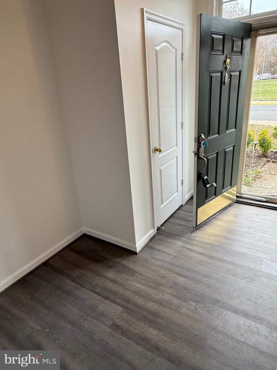 12976 Park Crescent Circle Herndon, VA 20171 - Photo 2 of 15 an empty room with wooden floor and a large window