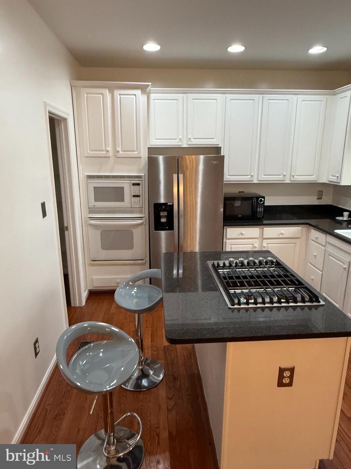 12976 Park Crescent Circle Herndon, VA 20171 - Photo 6 of 15 a kitchen with stainless steel appliances granite countertop a stove a refrigerator and a stove