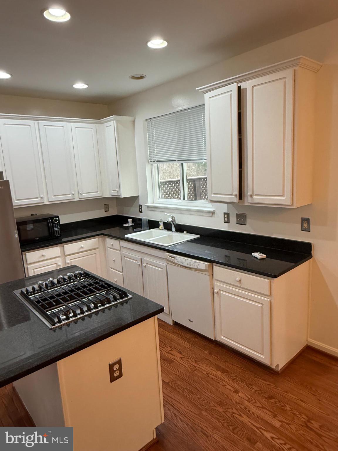 12976 Park Crescent Circle Herndon, VA 20171 - Photo 7 of 15 a kitchen with granite countertop a sink a stove and cabinets