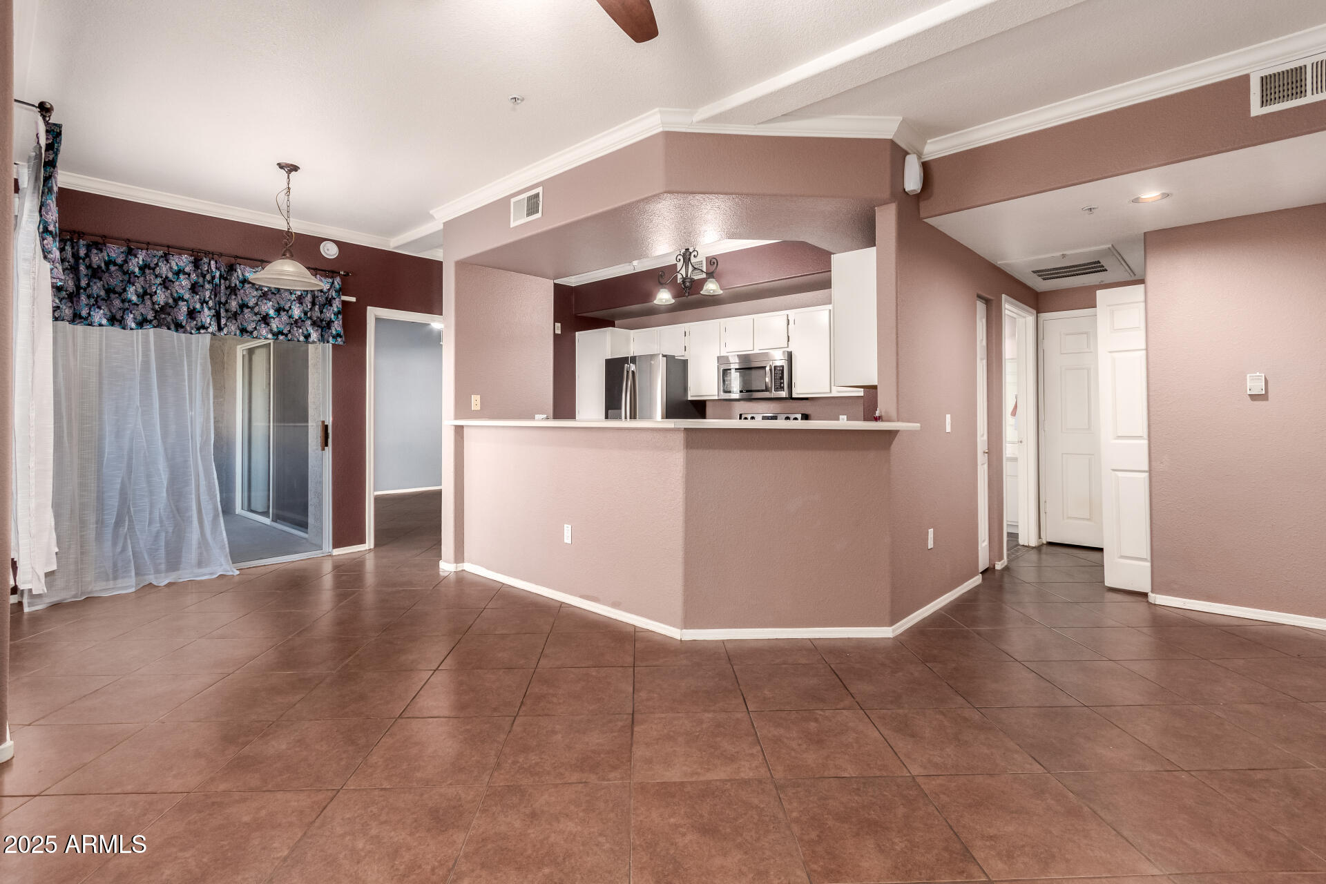 3236 East Chandler Boulevard, Unit 1082 Phoenix, AZ 85048 - Photo 11 of 28 a view of a kitchen with a refrigerator and windows
