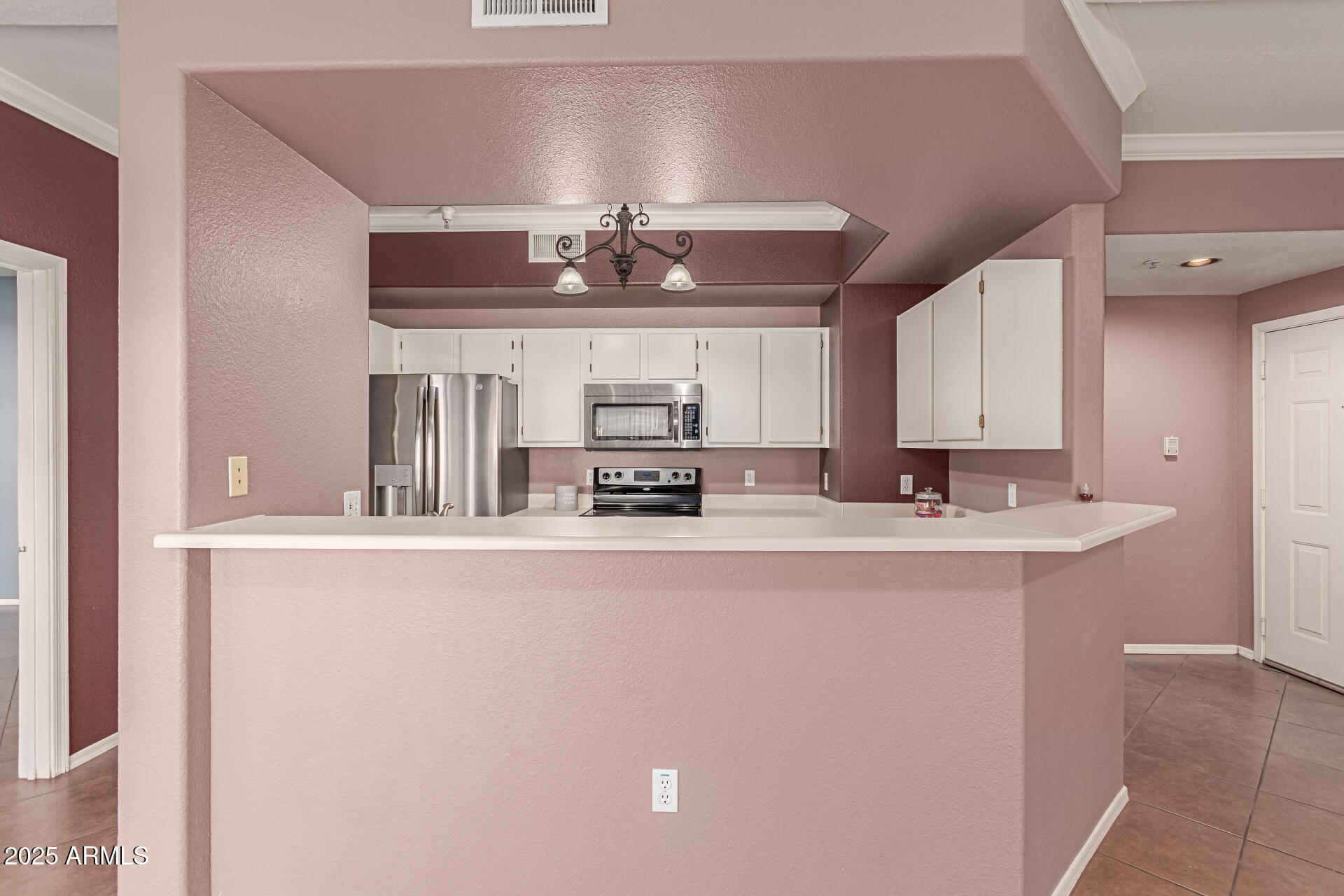 3236 East Chandler Boulevard, Unit 1082 Phoenix, AZ 85048 - Photo 12 of 28 a kitchen with stainless steel appliances a sink and stove