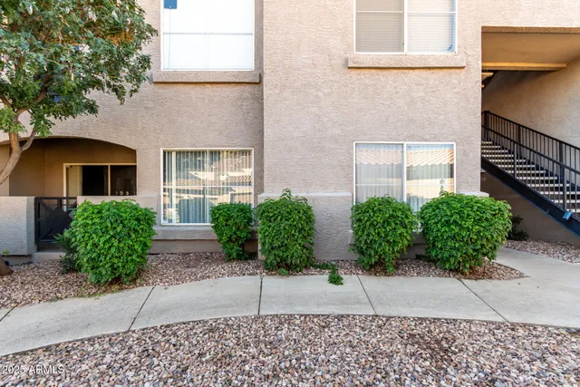 a house with potted plants in front of door
