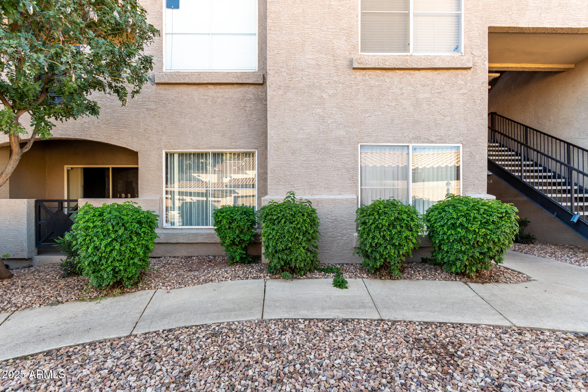 3236 East Chandler Boulevard, Unit 1082 Phoenix, AZ 85048 - Photo 2 of 28 a house with potted plants in front of door
