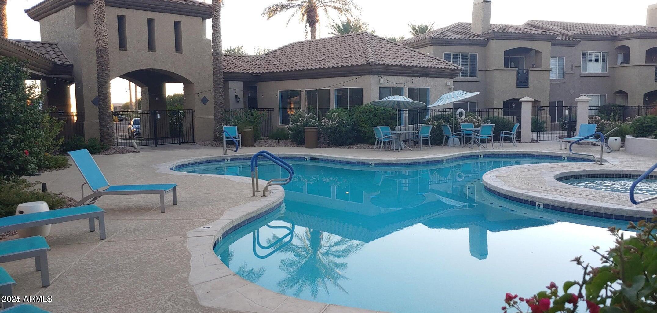 3236 East Chandler Boulevard, Unit 1082 Phoenix, AZ 85048 - Photo 22 of 28 a view of a house with a fountain back yard and sitting area