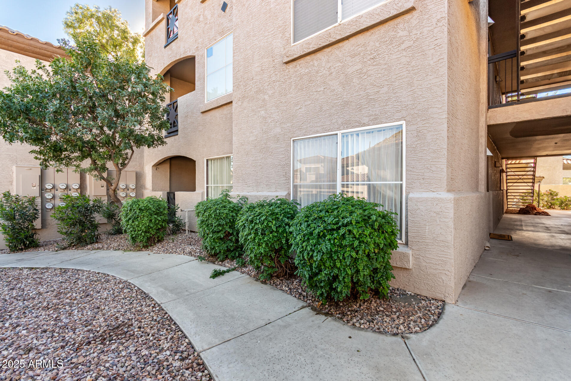 3236 East Chandler Boulevard, Unit 1082 Phoenix, AZ 85048 - Photo 4 of 28 a front view of a house with garden