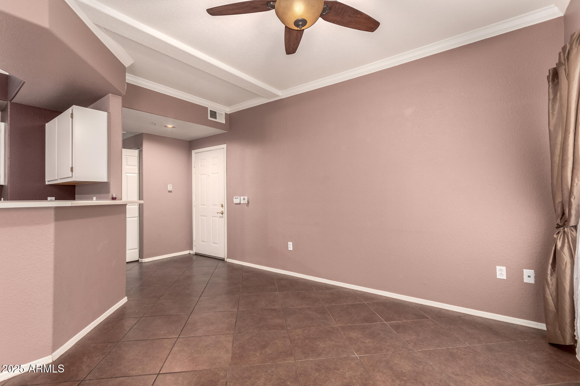 3236 East Chandler Boulevard, Unit 1082 Phoenix, AZ 85048 - Photo 8 of 28 a view of a livingroom with a ceiling fan and kitchen view