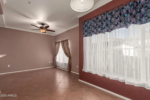 a view of a kitchen with a refrigerator and windows