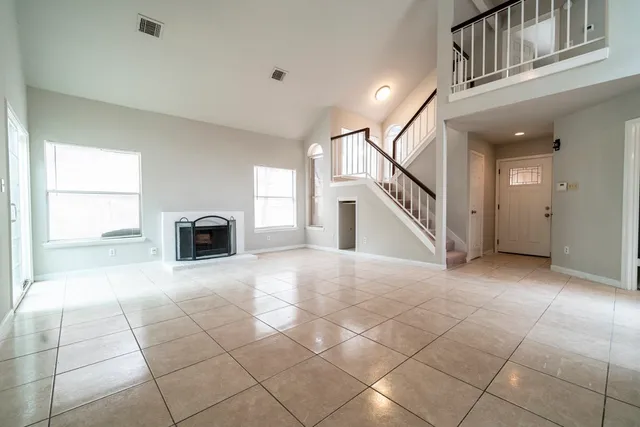 a view of a livingroom with an empty space and a fireplace