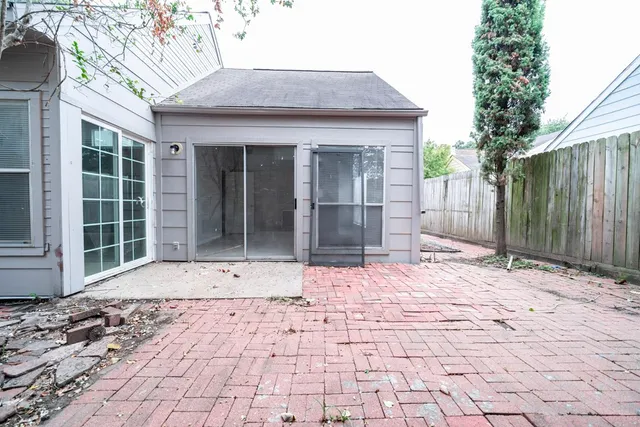 a view of a brick house with a yard