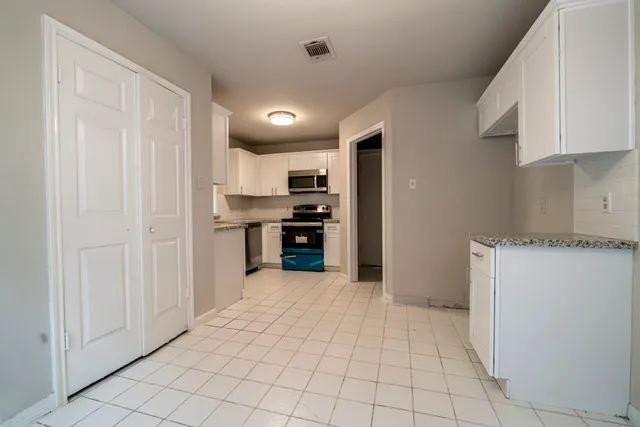 a view of a kitchen with electric appliances