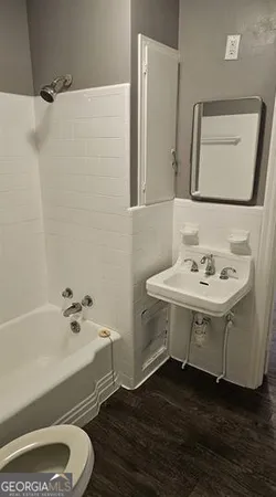 a bathroom with a sink a toilet and bathtub
