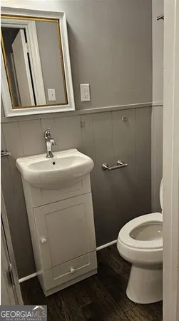 a bathroom with a sink a toilet and a mirror
