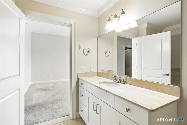 a bathroom with a sink vanity and a mirror