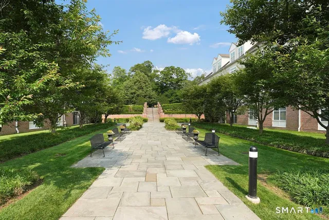 a view of a chairs and table in the patio with a garden