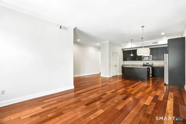 a kitchen with stainless steel appliances a refrigerator and a stove top oven