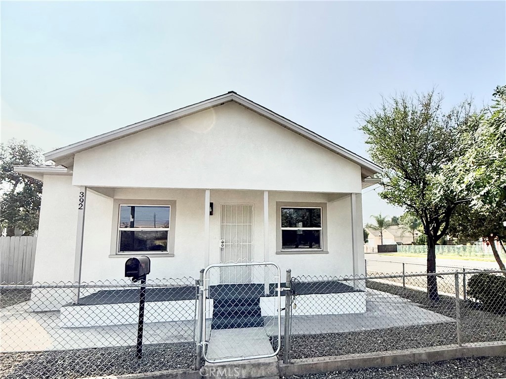 392 West L Street Colton, CA 92324 - Photo 1 of 41 a front view of a house with garden