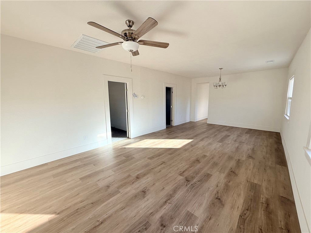 392 West L Street Colton, CA 92324 - Photo 15 of 41 an empty room with wooden floor and ceiling fan
