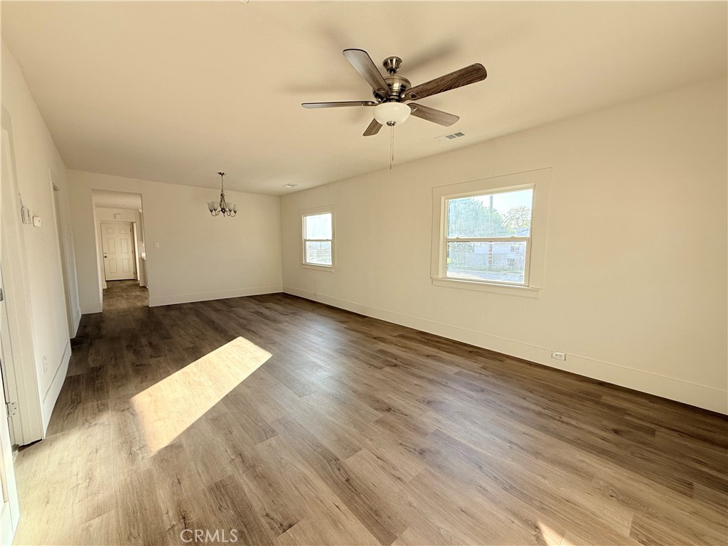 392 West L Street Colton, CA 92324 - Photo 16 of 41 an empty room with wooden floor fan and windows