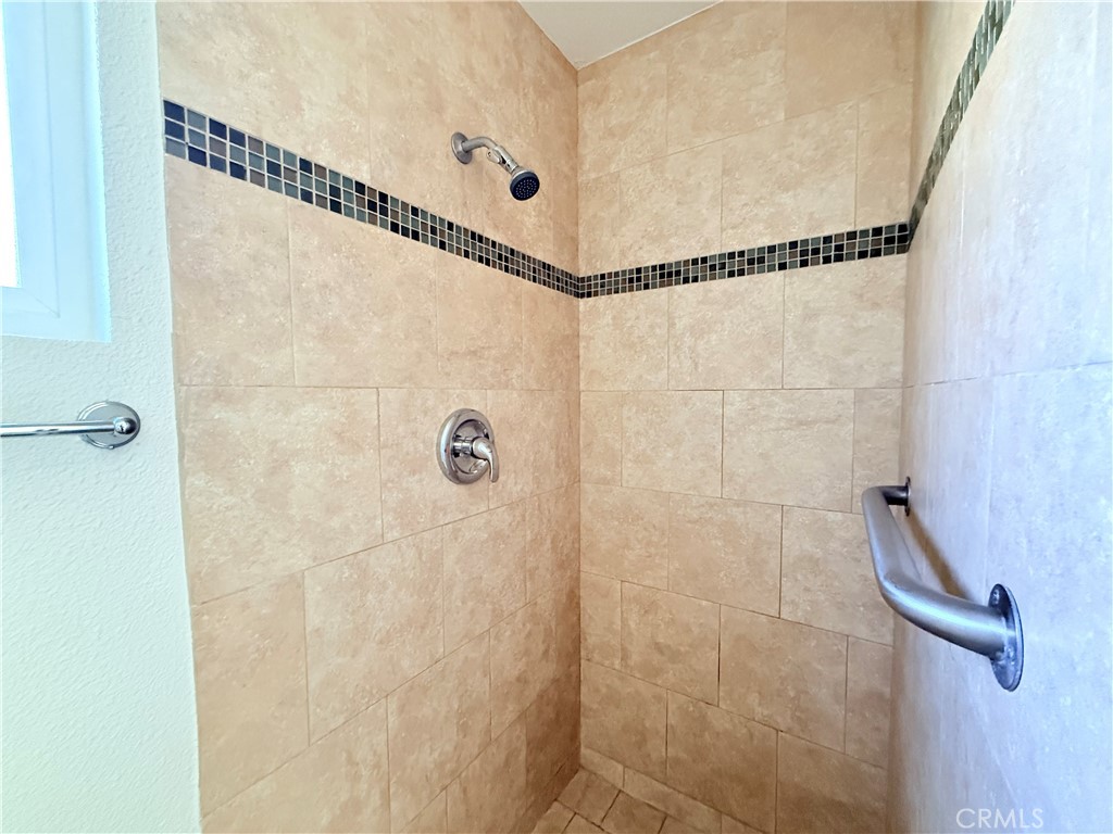 392 West L Street Colton, CA 92324 - Photo 17 of 41 a bathroom with a shower and a mirror