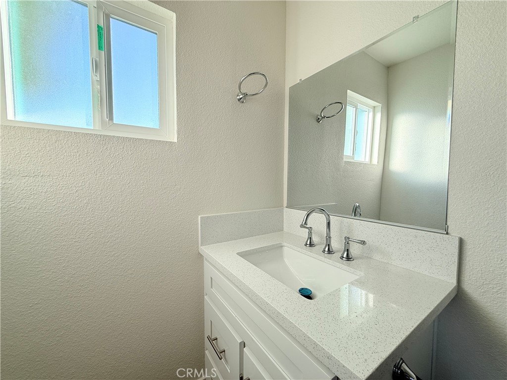 392 West L Street Colton, CA 92324 - Photo 21 of 41 a bathroom with a sink vanity and a mirror