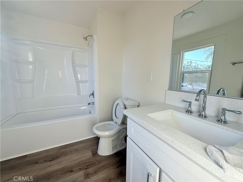 392 West L Street Colton, CA 92324 - Photo 22 of 41 a spacious bathroom with a granite countertop sink toilet a mirror and a bathtub