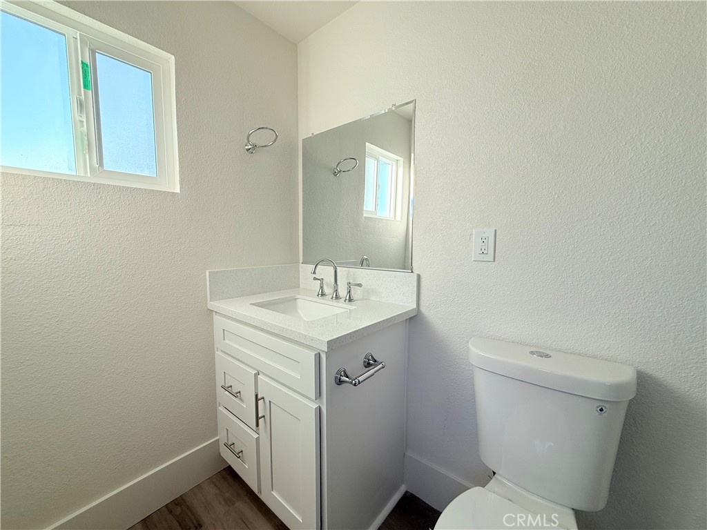 392 West L Street Colton, CA 92324 - Photo 23 of 41 a bathroom with a toilet sink and mirror