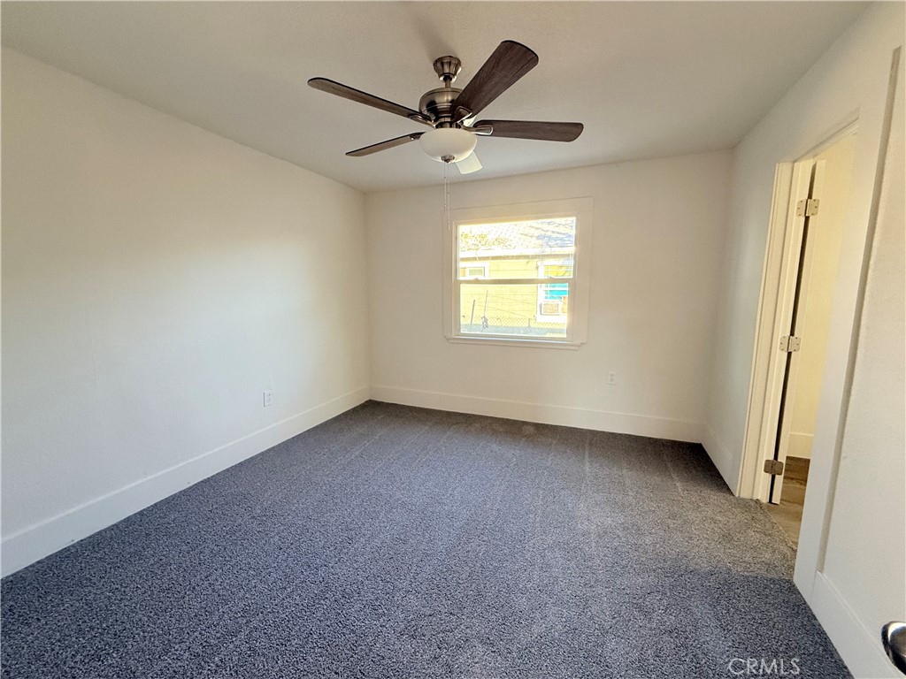 392 West L Street Colton, CA 92324 - Photo 27 of 41 an empty room with a ceiling fan and window