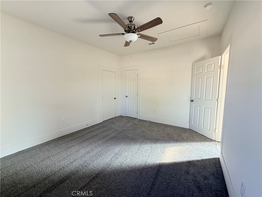 392 West L Street Colton, CA 92324 - Photo 28 of 41 an empty room with closet and ceiling fan