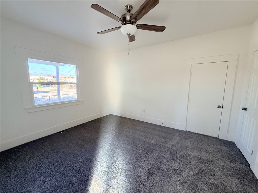 392 West L Street Colton, CA 92324 - Photo 30 of 41 an empty room with wooden floor ceiling fan and windows
