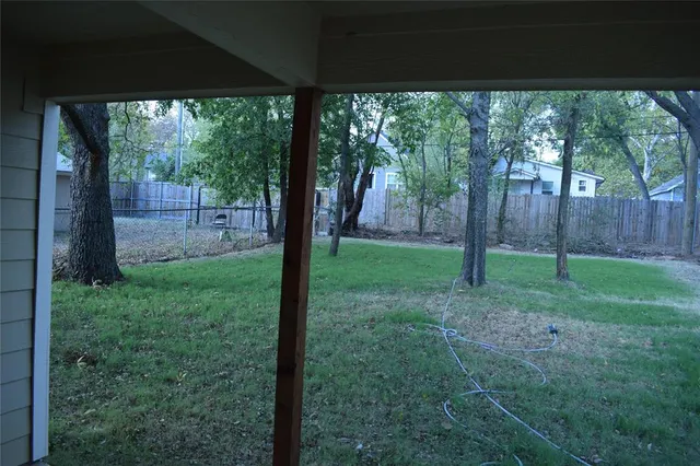 a view of a yard with a tree