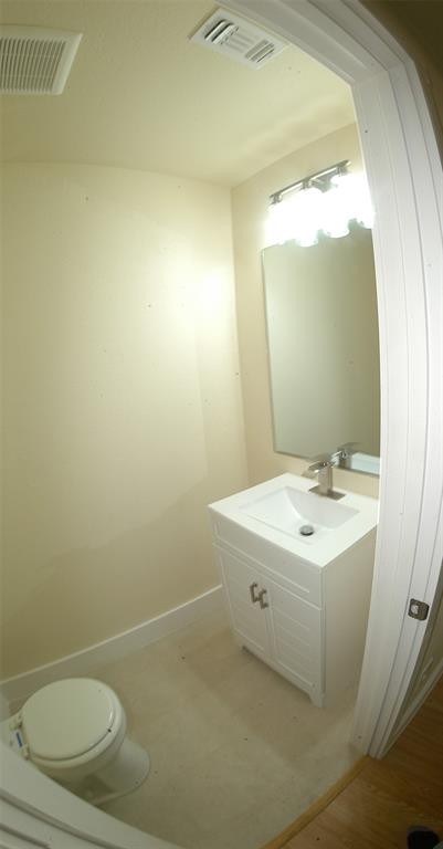 621 East Murray Street Denison, TX 75021 - Photo 16 of 31 a bathroom with a sink a toilet and a mirror