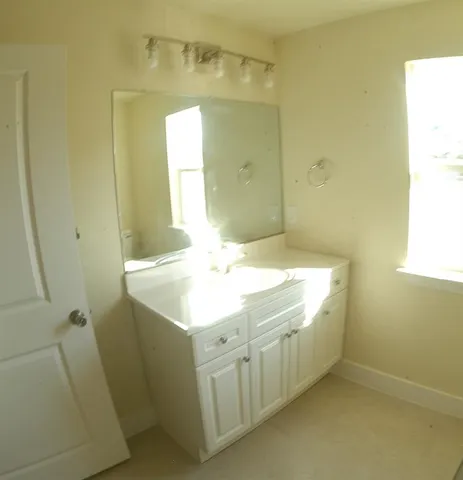 a bathroom with a sink a toilet and a mirror