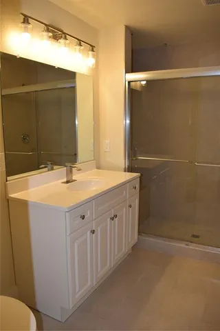 a bathroom with a double vanity sink and mirror