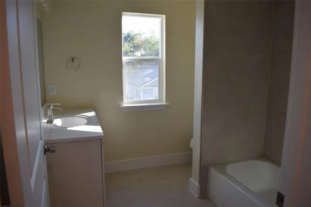 a bathroom with a toilet sink and tub