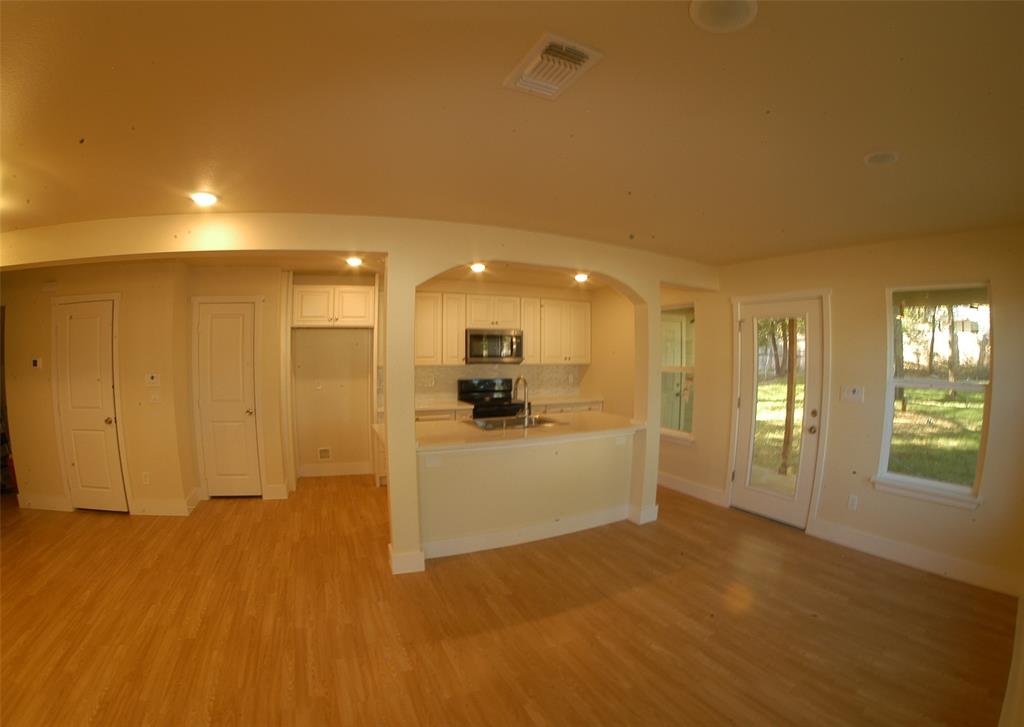 621 East Murray Street Denison, TX 75021 - Photo 3 of 31 a view of a hallway with wooden floor and a living room