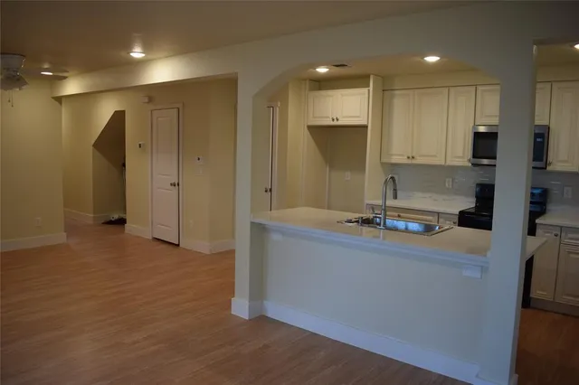 a kitchen with stainless steel appliances granite countertop a refrigerator a sink and a stove