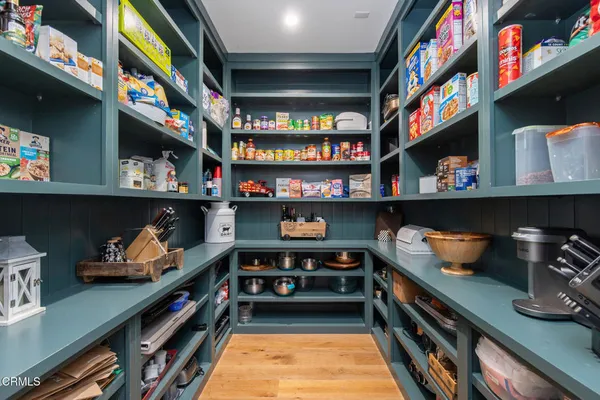 a living room with a large mirror and a table