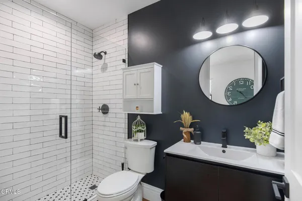 a spacious bathroom with a granite countertop sink mirror and shower