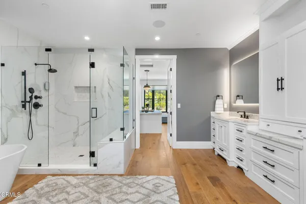 a bedroom with furniture and large window