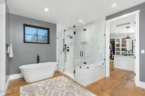 a view of a balcony with chairs and wooden floor