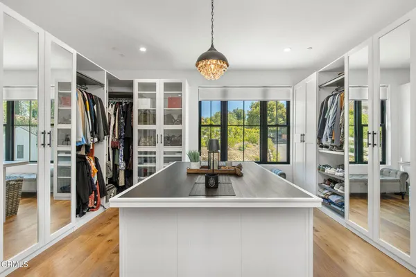 a bedroom with furniture and a flat screen tv