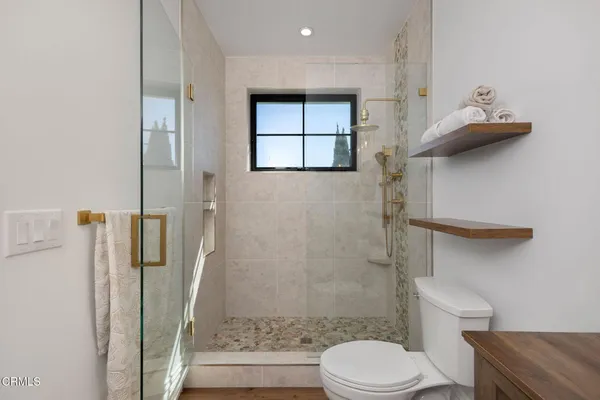 a view of multiple houses with yard and green space