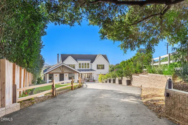 a view of a livingroom with furniture wooden floor and windows