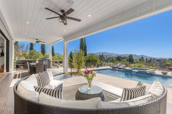 a view of a house with a wooden fence
